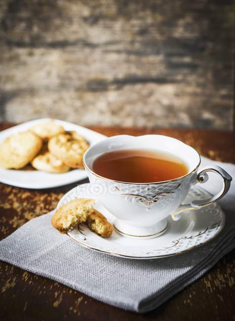 focused_154617970-stock-photo-cup-of-tea-and-biscuits