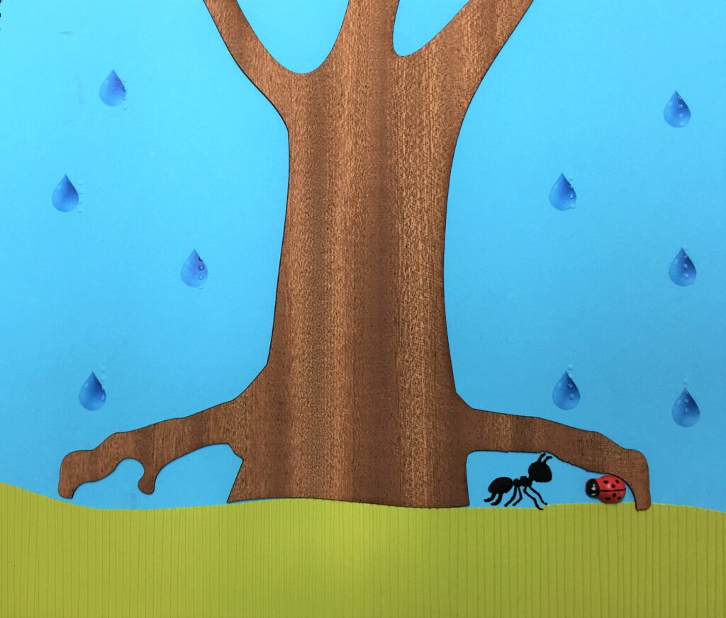Il·lustració en relleu de la formiga i la marieta amagades de la pluja sota un arbre.