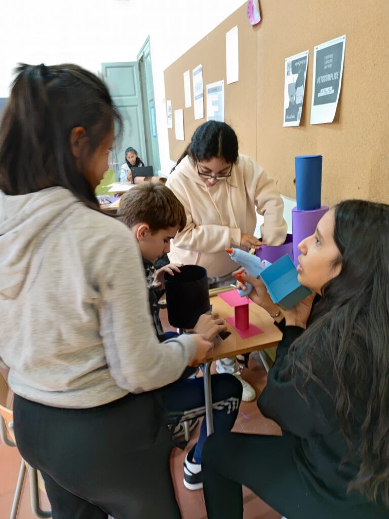 Alumnes fent, amb cartolina, barrets matemàtics.