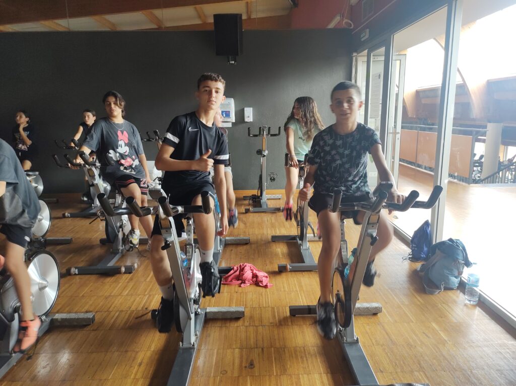 Dos alumnes de 1r d'ESO fent una classe de ciclisme de sala